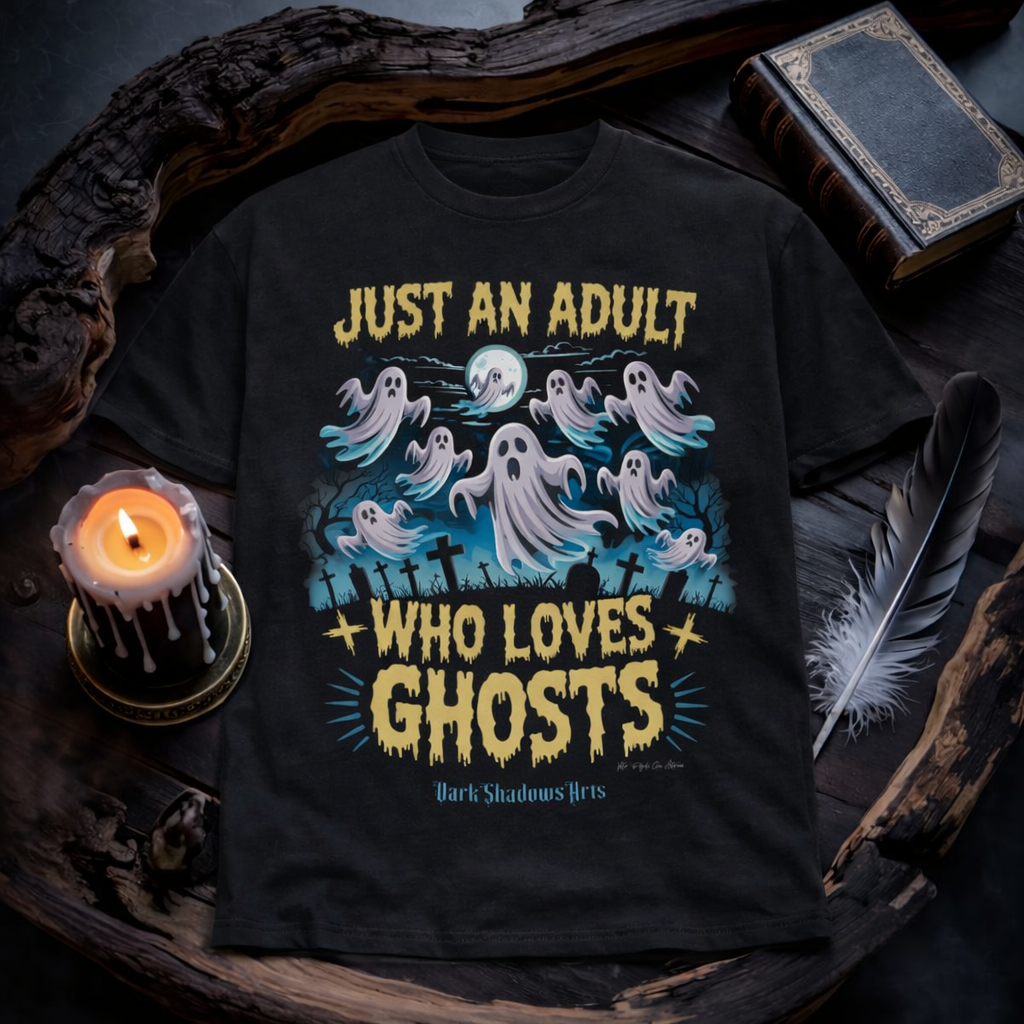 Just an Adult Who Loves Ghosts Premium T-Shirt von Dark Shadows Arts im düsteren Flatlay Mockup mit Kerzenlicht, altem Buch und mystischer Atmosphäre – Geister und Friedhof Motiv unter Vollmond auf schwarzem Shirt
